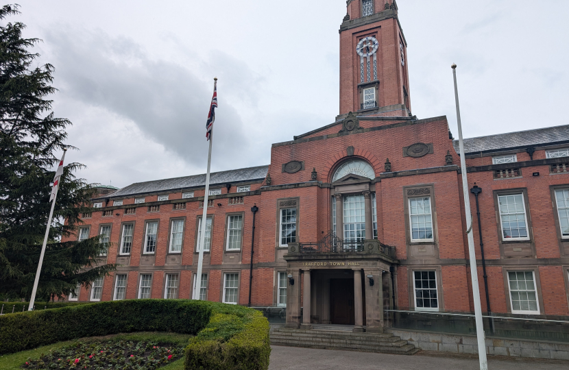 photo of the front of Trafford Town Hall on a cloudy rainy day