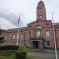 photo of the front of Trafford Town Hall on a cloudy rainy day