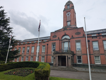 photo of the front of Trafford Town Hall on a cloudy rainy day